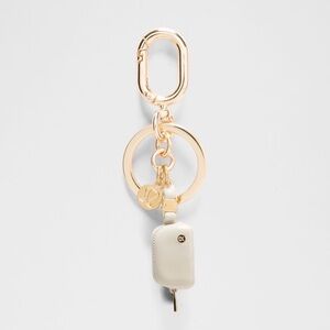 Lululemon Everywhere Belt Bag Charm Gold and Cream Keychain